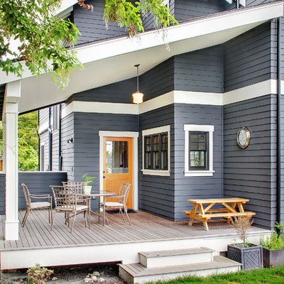 Mid-sized elegant backyard deck container garden photo in Seattle with a roof extension