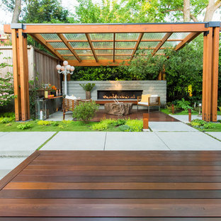 Inspiration for a mid-sized contemporary backyard deck remodel in Seattle with a fireplace