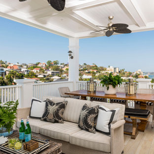 Design ideas for a beach style deck in Brisbane with a roof extension.