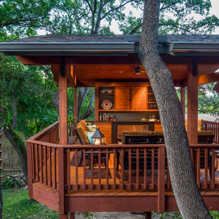 Immagine di una terrazza contemporanea di medie dimensioni e dietro casa con un focolare e un tetto a sbalzo