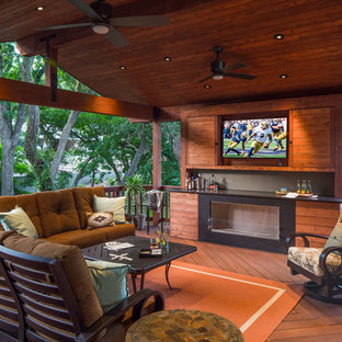 Mid-sized trendy backyard deck photo in Austin with a fire pit and a roof extension