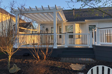 Example of a large eclectic backyard deck design in Columbus with a pergola