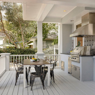 Inspiration for a large transitional backyard outdoor kitchen deck remodel in Tampa with a roof extension
