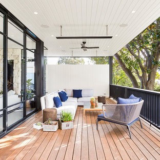Photo of a contemporary deck in Melbourne with a roof extension.