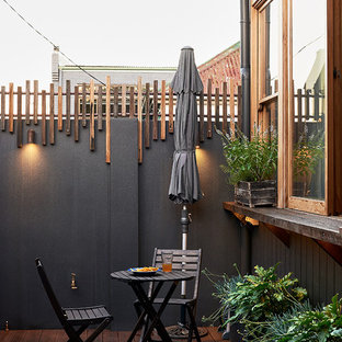 Inspiration for a small contemporary courtyard deck container garden remodel in Sydney with no cover