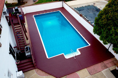 Pool - large modern backyard pool idea in New York