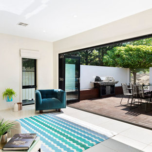 Example of a large trendy courtyard outdoor kitchen deck design in Canberra - Queanbeyan with an awning