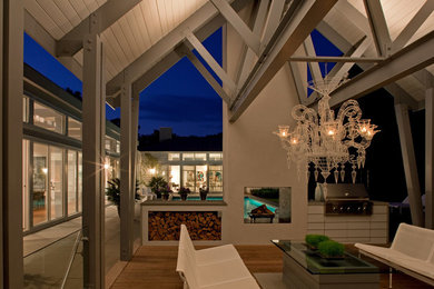 Réalisation d'une terrasse design de taille moyenne avec une extension de toiture.