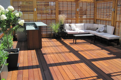 Deck - large contemporary rooftop deck idea in Chicago with a pergola