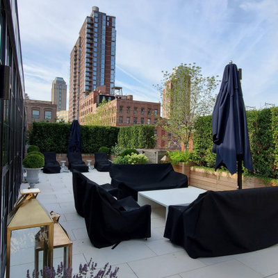 Deck container garden - large contemporary rooftop deck container garden idea in New York with no cover