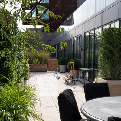 Large trendy rooftop deck container garden photo in New York with no cover