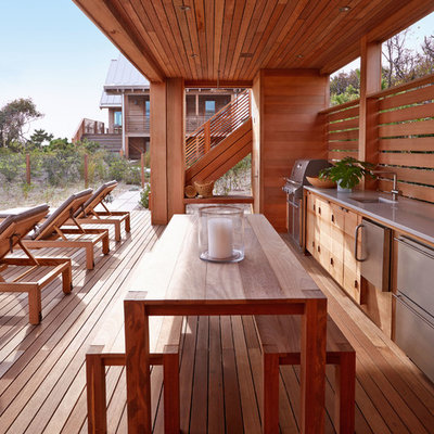 Inspiration for a large coastal backyard outdoor kitchen deck remodel in New York with a roof extension