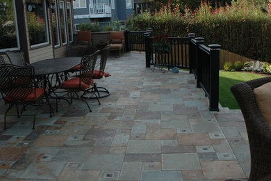 Inspiration for a large eclectic back patio in Portland with a fire feature and tiled flooring.