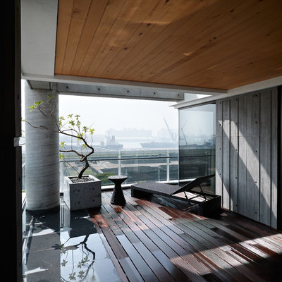 Example of a trendy deck container garden design in Other with a roof extension