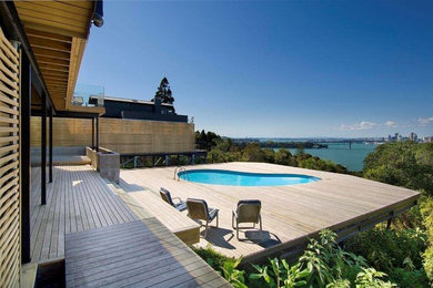 Expansive world-inspired back terrace in Auckland with no cover.