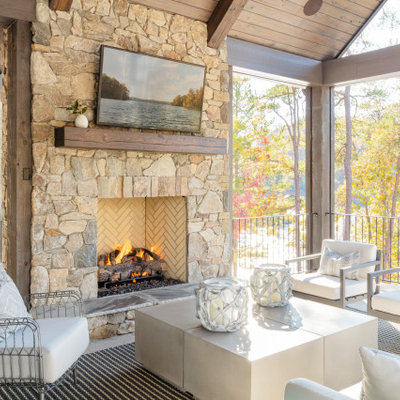 Example of a mid-sized beach style backyard deck design in Other with a fireplace and a roof extension