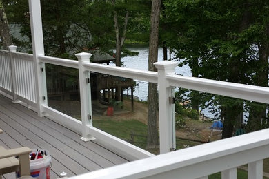 Example of a mid-sized classic backyard deck design in Boston with no cover