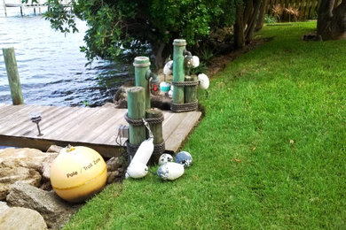 Water fountain deck - coastal backyard water fountain deck idea in Orlando with no cover