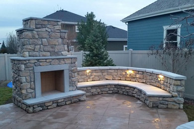 Example of a mid-sized classic backyard patio design in Salt Lake City with a fire pit