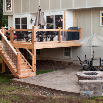 Leeder - Cedar deck in Kansas City with stamped concrete patio and firepit.