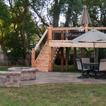 Leeder - Cedar deck in Kansas City with stamped concrete patio and firepit.