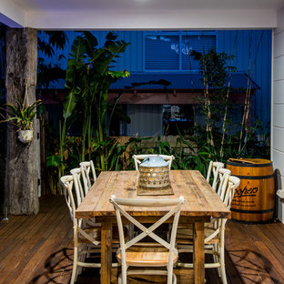 Foto di una terrazza tropicale dietro casa con un tetto a sbalzo