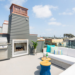 Mid-sized beach style rooftop rooftop deck photo in Orange County with a fireplace and no cover
