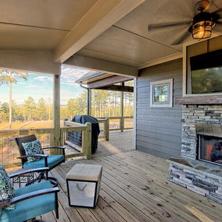Mid-sized mountain style backyard deck photo in Atlanta with a fireplace and a roof extension