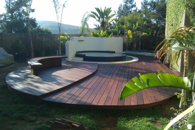 Water fountain deck - large contemporary backyard water fountain deck idea in Orange County with no cover