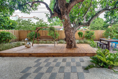 Example of a trendy backyard deck design in Miami with no cover