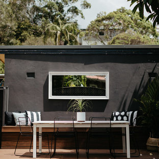 Design ideas for a small beach style backyard deck in Sydney with no cover.