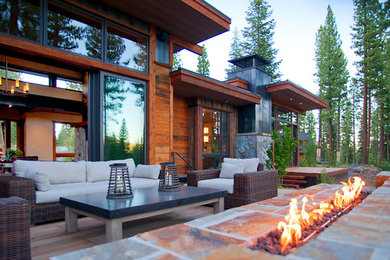 Mountain style backyard deck photo in Sacramento with a roof extension