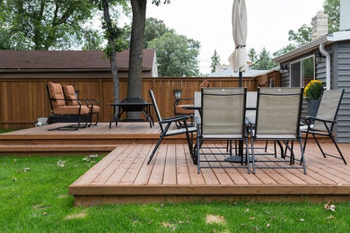 Deck - large traditional backyard deck idea in Other with a fire pit and no cover