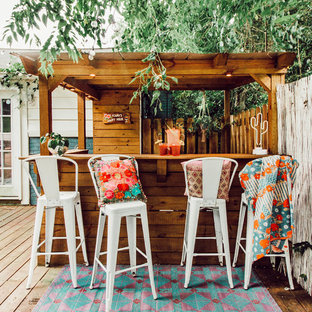 Eclectic backyard deck photo in Nashville with a pergola