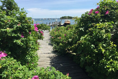 Design ideas for a large nautical back terrace in Boston with a dock and no cover.