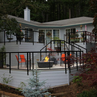 Deck skirting - large modern backyard deck skirting idea in Other with no cover