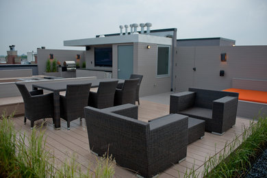 Immagine di una grande terrazza moderna sul tetto con un focolare e nessuna copertura