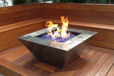 Example of a small trendy backyard deck design in San Francisco with a fire pit and no cover