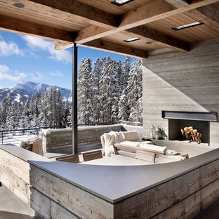 Deck - rustic deck idea in Other with a fireplace and a roof extension