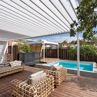 Mid-sized transitional backyard deck in Perth with a pergola.