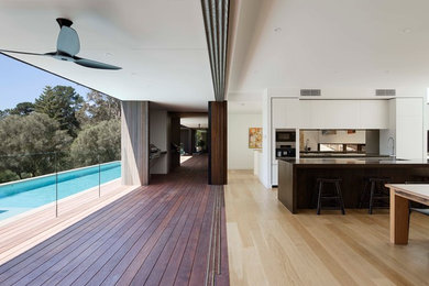Deck - large contemporary backyard deck idea in Melbourne with a roof extension