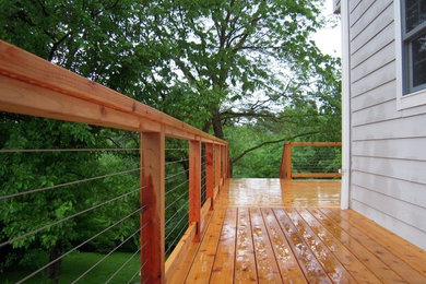 Large elegant backyard deck photo in Other with no cover