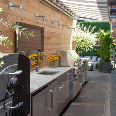 Inspiration for a large contemporary rooftop rooftop deck remodel in New York with an awning