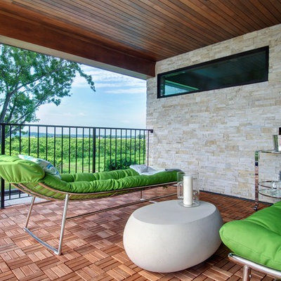 Deck - contemporary deck idea in Toronto with a roof extension