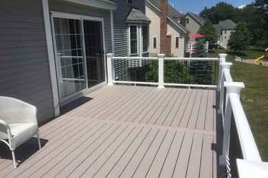 Example of a classic backyard deck design in Boston with no cover
