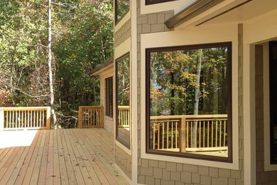 Large transitional backyard deck photo in Other with no cover