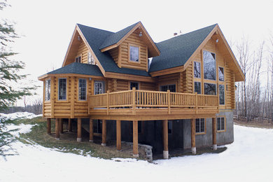 Large mountain style backyard deck photo in Other