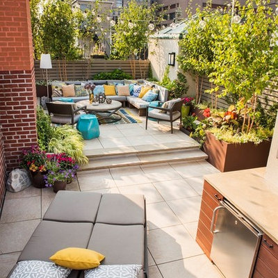 Outdoor kitchen deck - large modern rooftop outdoor kitchen deck idea in New York with no cover