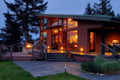 Photo of a large modern back terrace in Seattle with a fire feature and no cover.