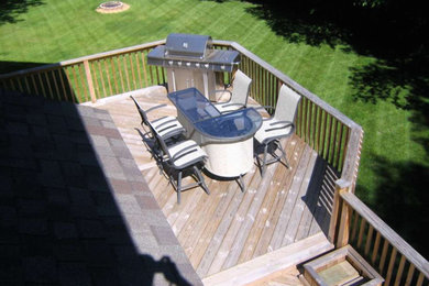 Example of a mid-sized classic backyard outdoor kitchen deck design in Grand Rapids with no cover
